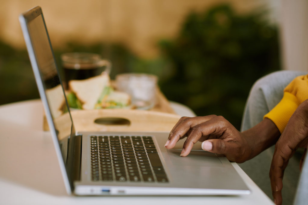 Woman looking up fundraising hacks on a laptop